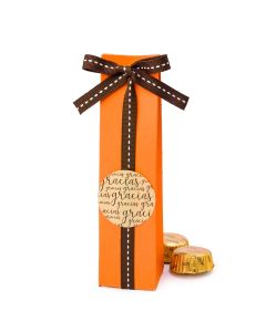 Orange box decorated with brown ribbon and label, 2 chocolates