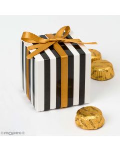 White box with black stripes with 3 chocolates