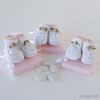 Pink crochet baby shoe with 5 sug. coated choc.